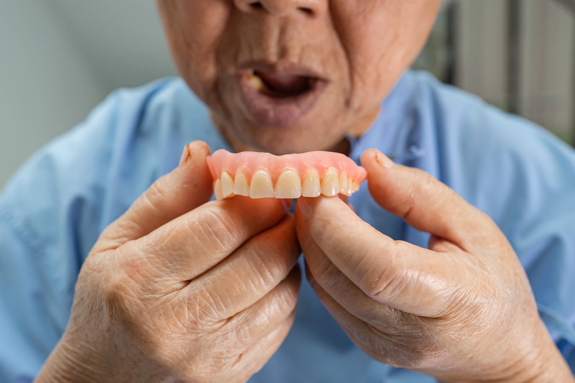 Senior person getting used to their dentures