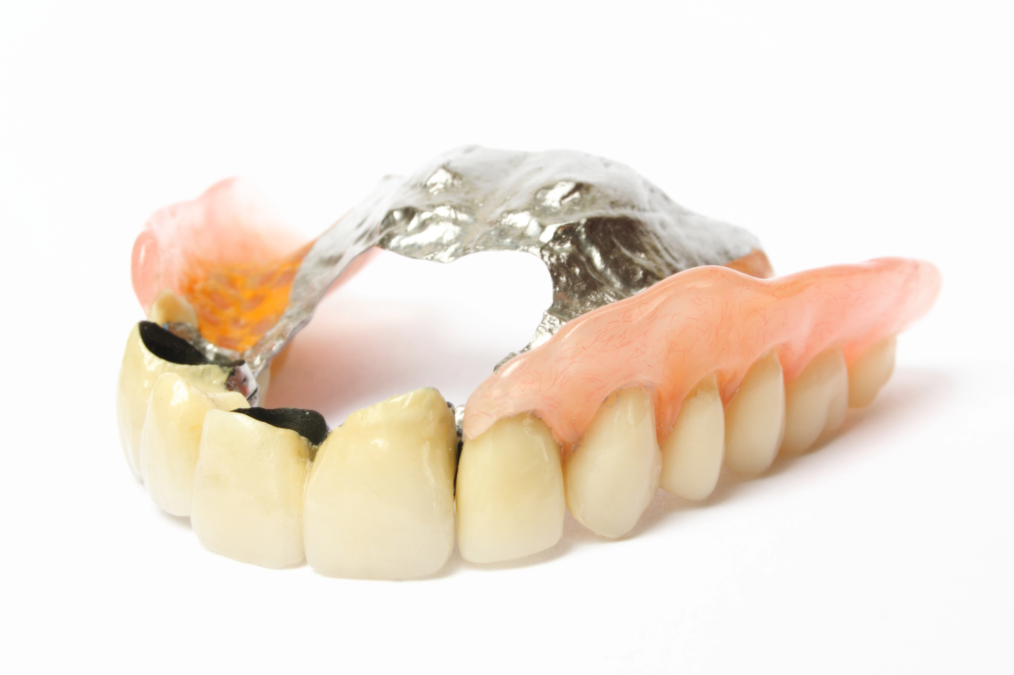 photo of complete dentures on a white background